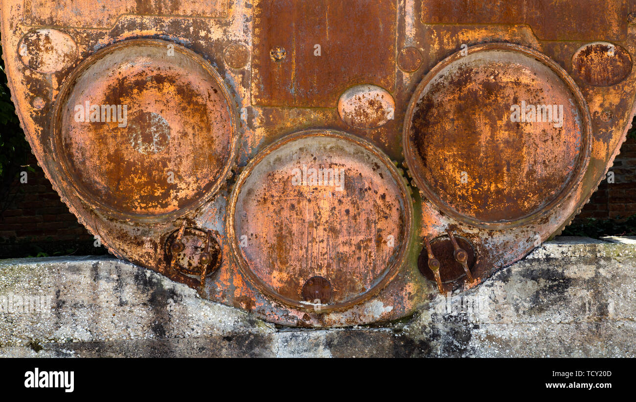 Big rusted barrel with three round lids Stock Photo