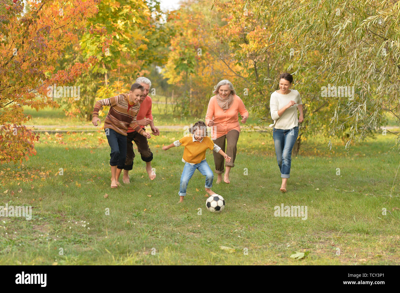 Portrait of big happy family playing football in park Stock Photo - Alamy