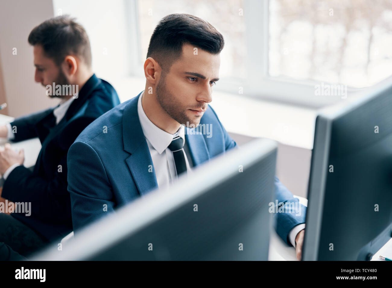 Young business man working on computer in his workplace. Office life concept Stock Photo