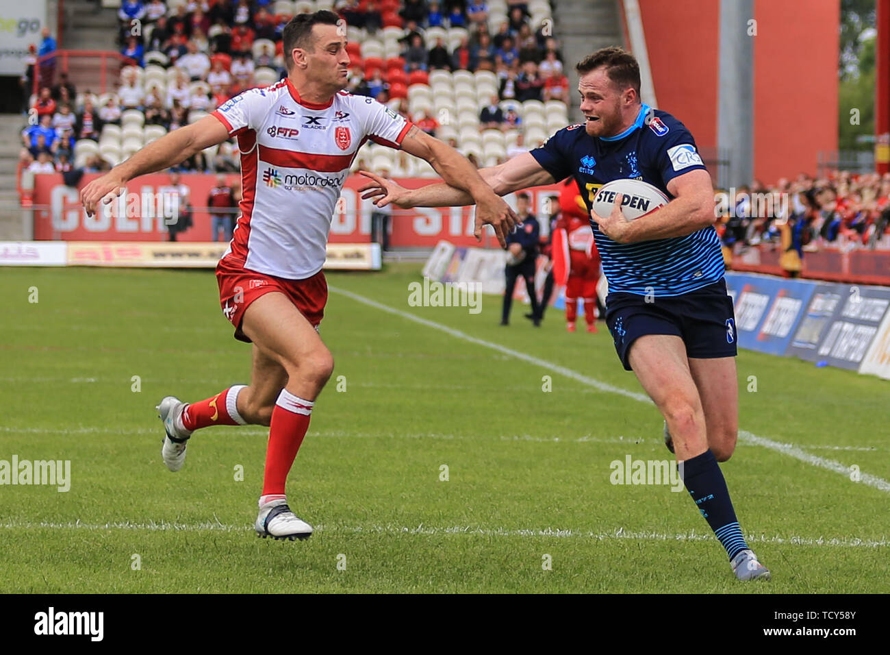 9th June 2019 , KCOM Craven Park, Hull, England;  Betfred Super League, Round 17, Hull KR vs Wigan Warriors ; Joe Burgess (5) of Wigan Warriors holds off Craig Hall (2) of Hull KR on his way to scoring his try    Credit: David Greaves/News Images Stock Photo