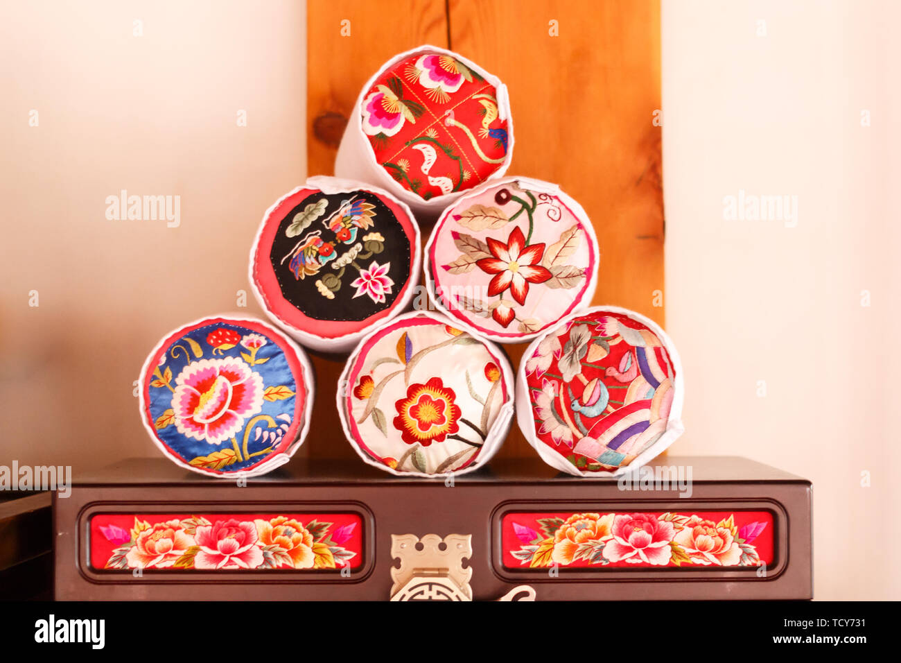 A stack of Korean traditional pillow embroidered with flowers on the