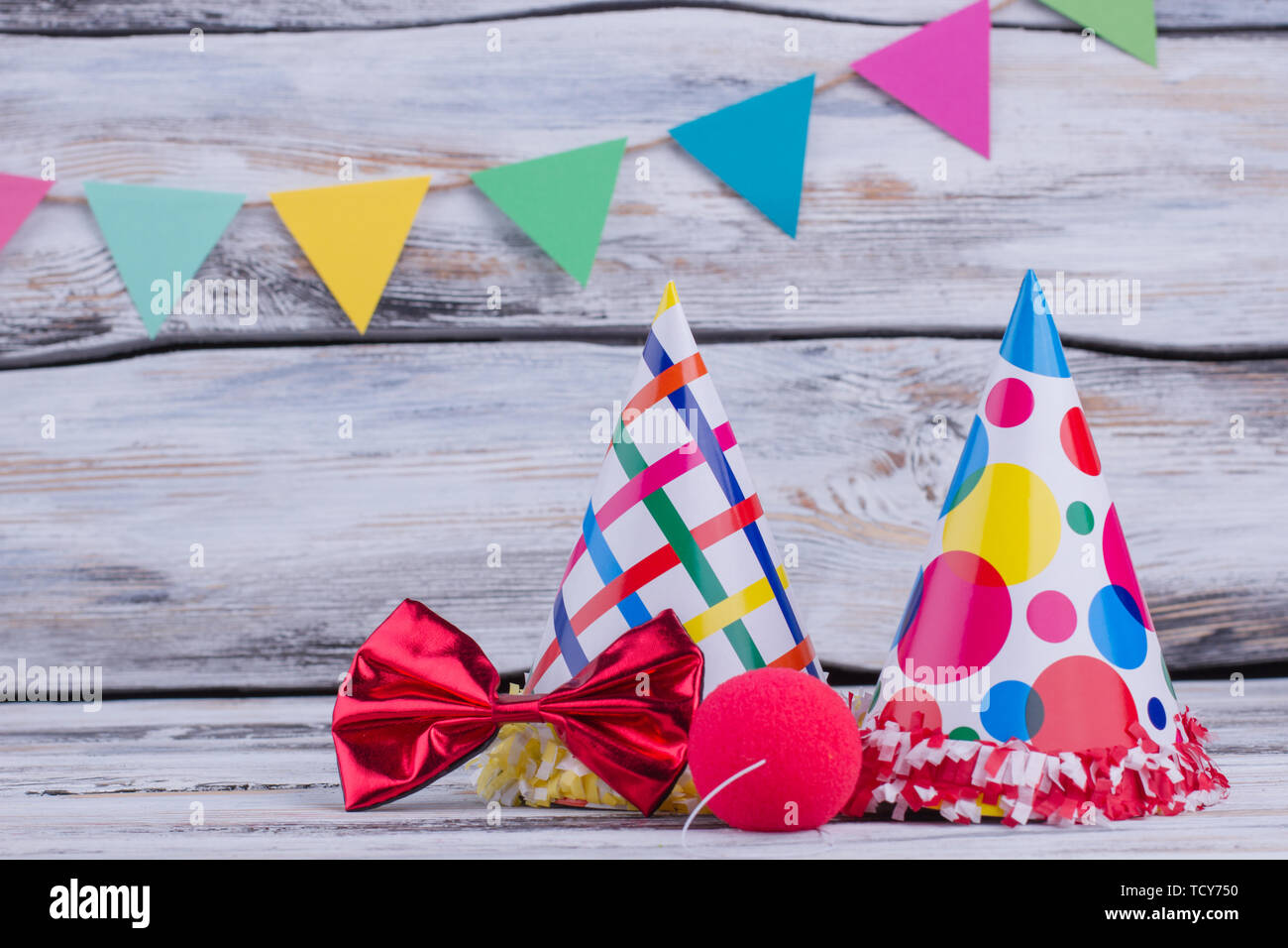 Party hats and other stuff on wooden background. Colorful