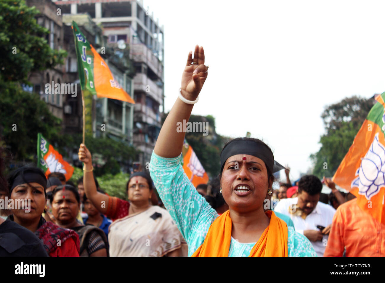 BJP Female worker chants slogans while making a gesture during the protest in Kolkata. At least four people were killed and three others severely injured in the clashes that broke out between All India Trinamool Congress and Bhartiya Janata Party supporters in Basirhat Area in North 24 Parganas district on Saturday night. It is claimed that the clashes broke out over removing flags of the political parties. State BJP general secretary Sayantan Basu said, three BJP Party Workers Sukanta Mondal, Pradip Mondal and Shankar Mondal died in this clash. Stock Photo