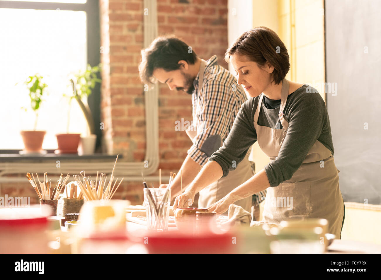 Man woman in pottery workshop hi-res stock photography and images - Alamy
