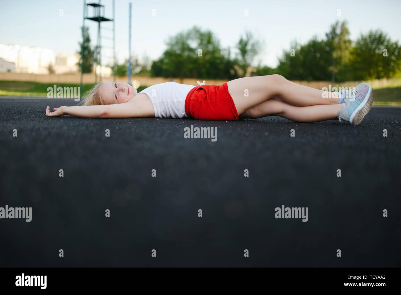 little girl lying on floor outdoors Stock Photo Alamy