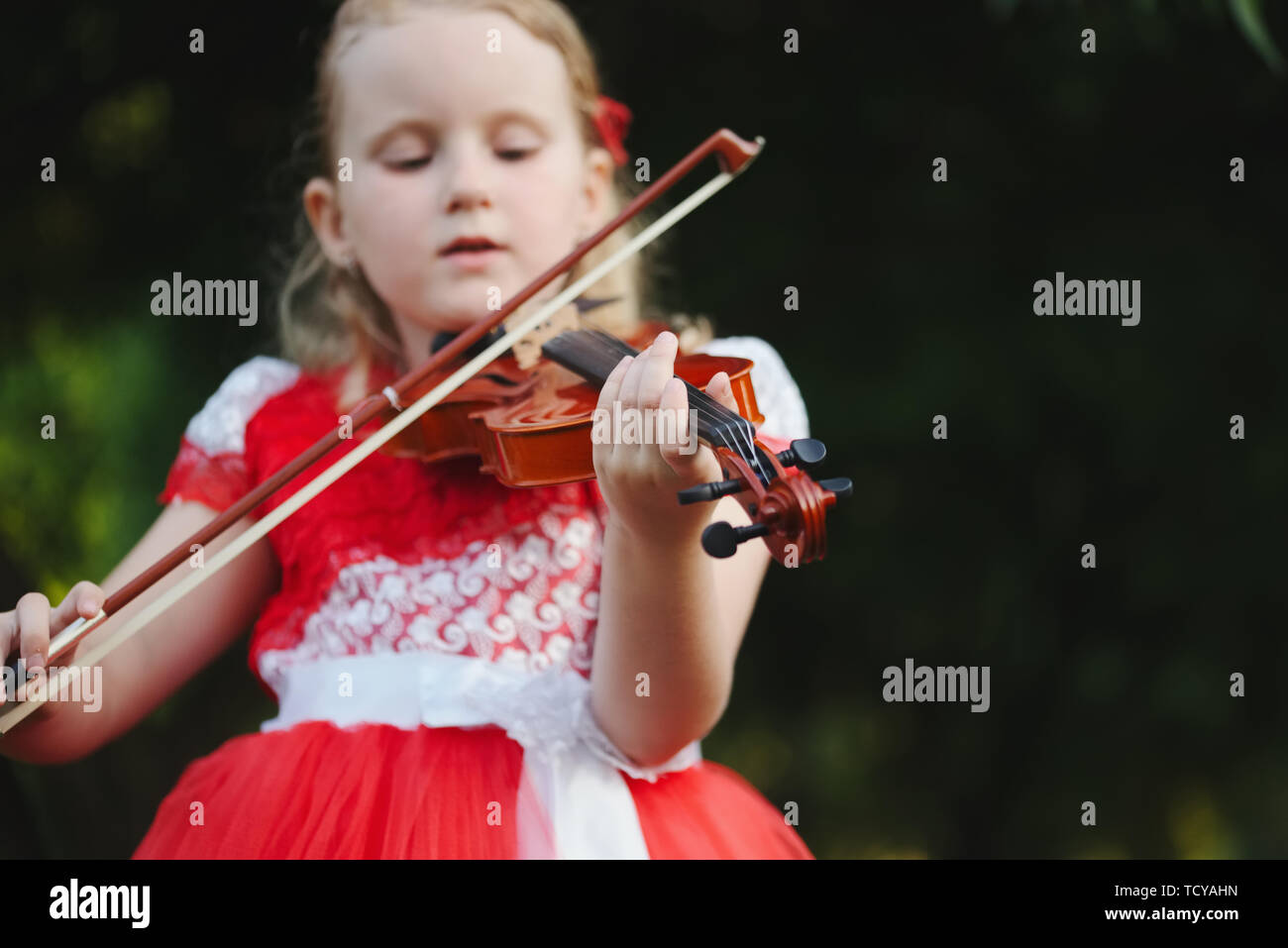 happy girl plays violin in summer park Stock Photo - Alamy