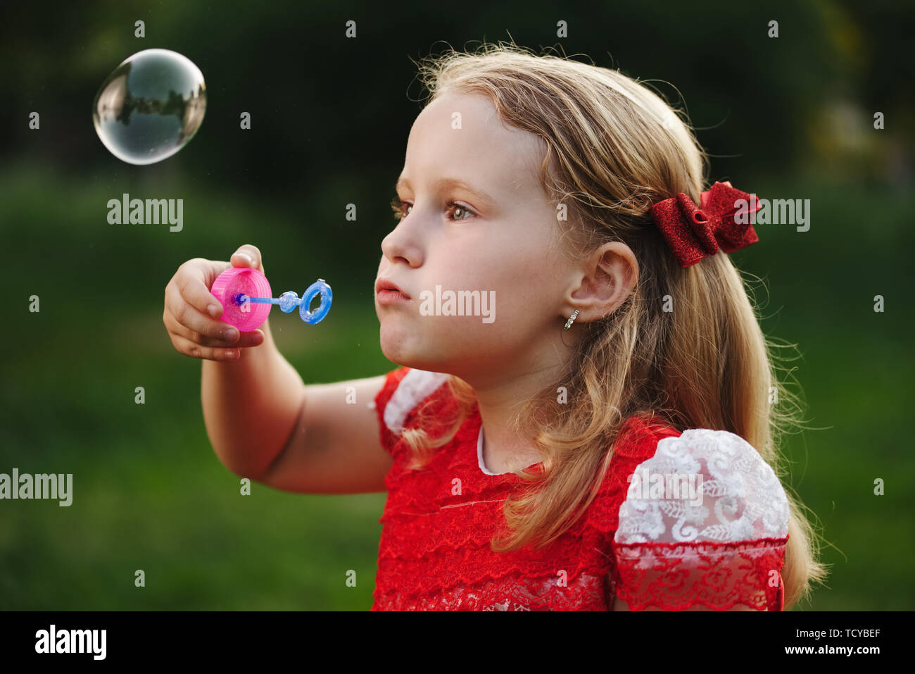 little girl with bubbles in summer park Stock Photo - Alamy