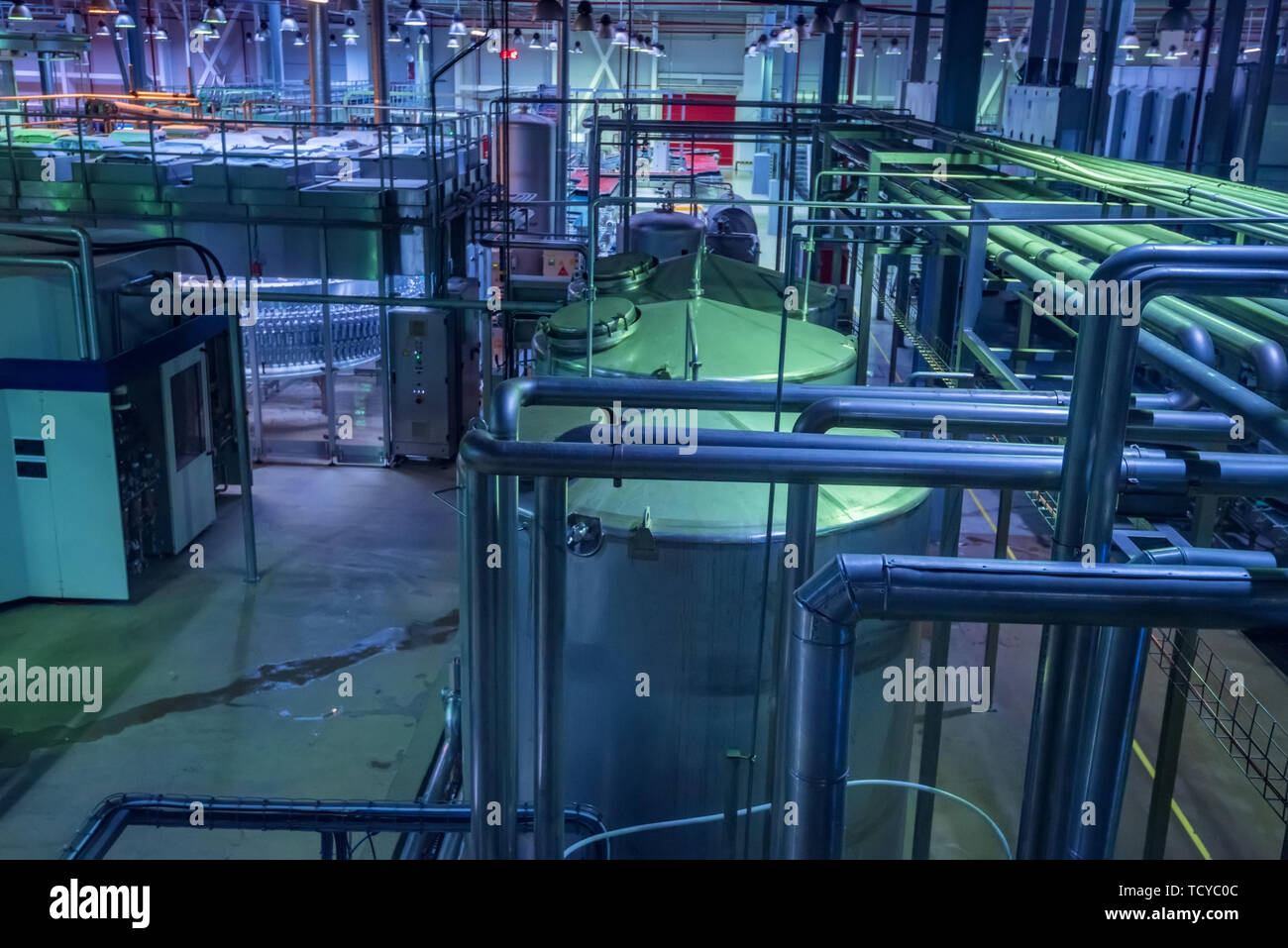 Industrial interior of soft drinks factory with tubes and reservoires