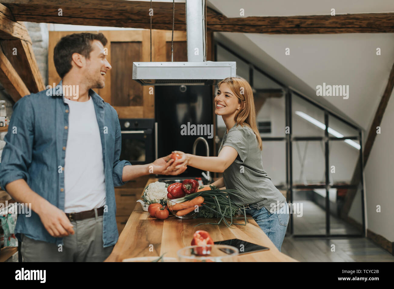 Lovely couple preparing food  in the kitchen Stock Photo