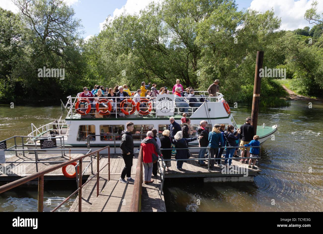 Tourists boarding a pleasure boat for a boat trip on the river Avon on a sunny summer day in June, from Bathampton to Bath, Somerset England UK Stock Photo