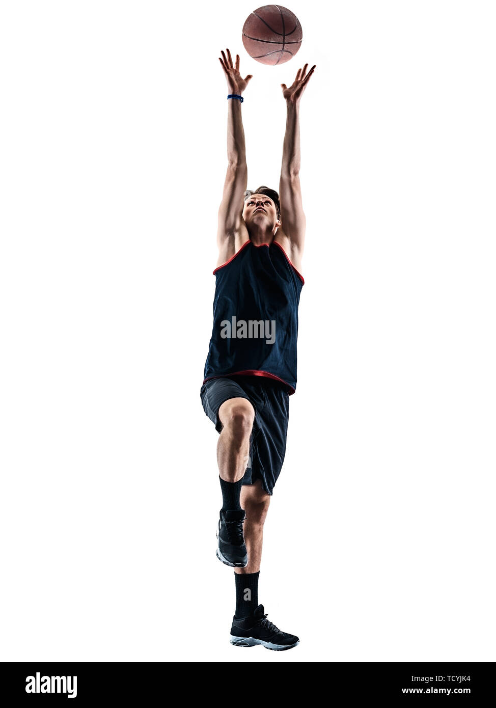one caucasian basketball player man isolated in silhouette shadow on white background Stock Photo