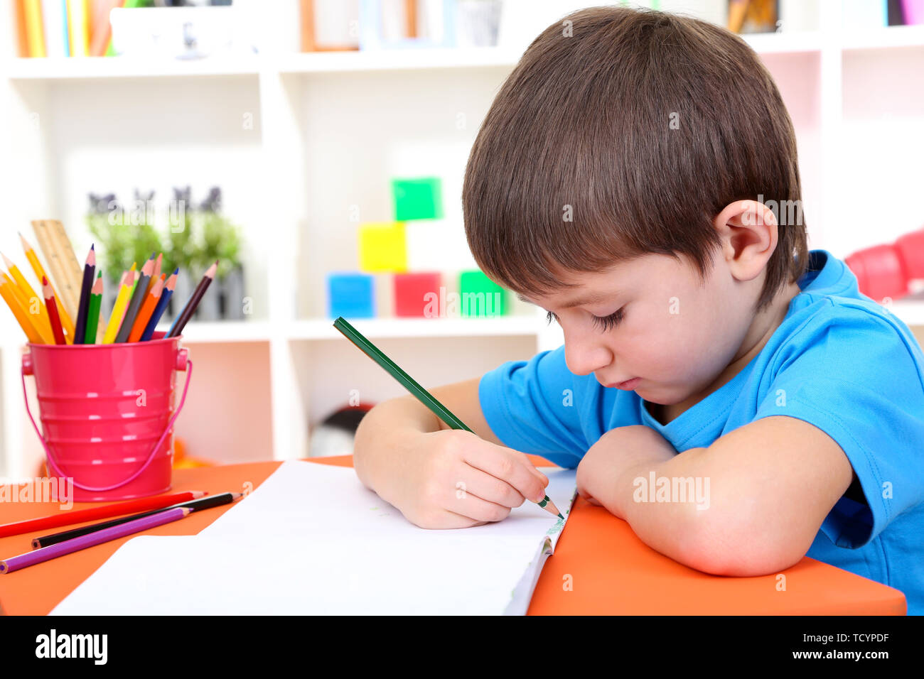 Cute little boy drawing in his album Stock Photo - Alamy