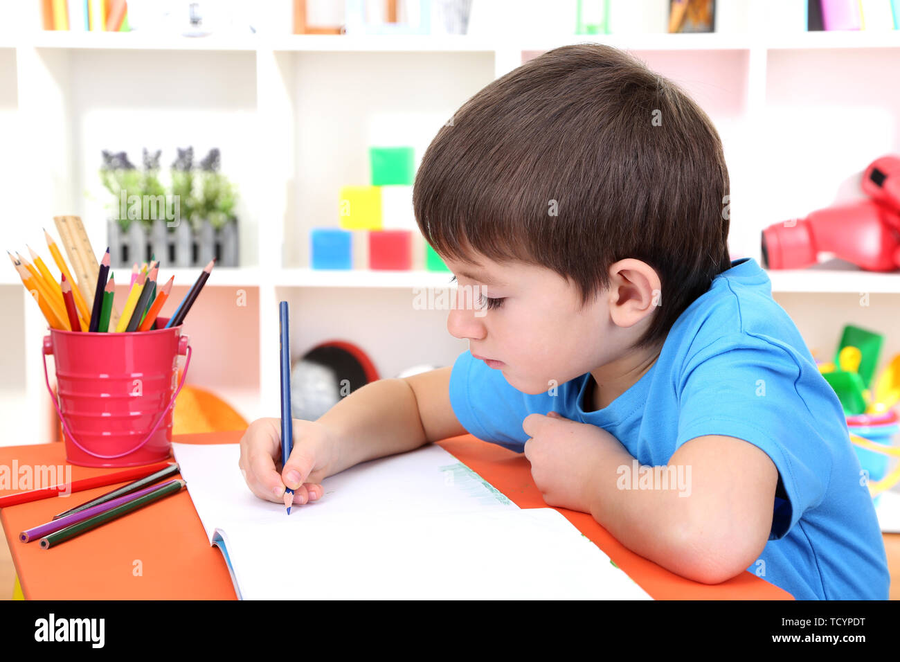 Cute little boy drawing in his album Stock Photo - Alamy