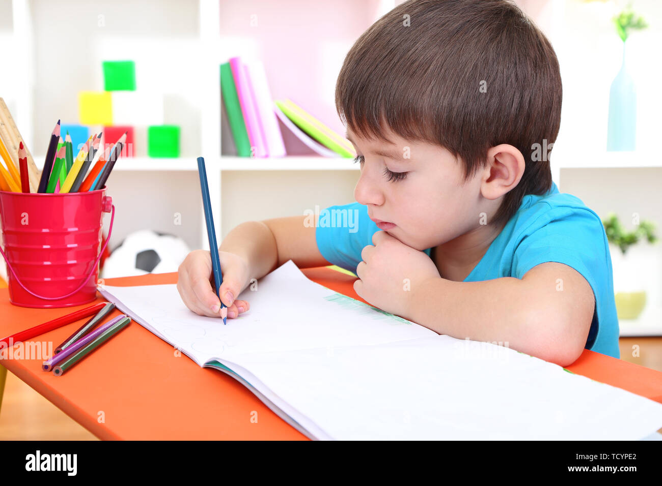 Cute little boy drawing in his album Stock Photo - Alamy