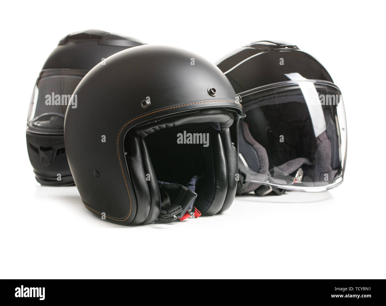 Three black motorcyle helmets isolated on white backgorund. Stock Photo