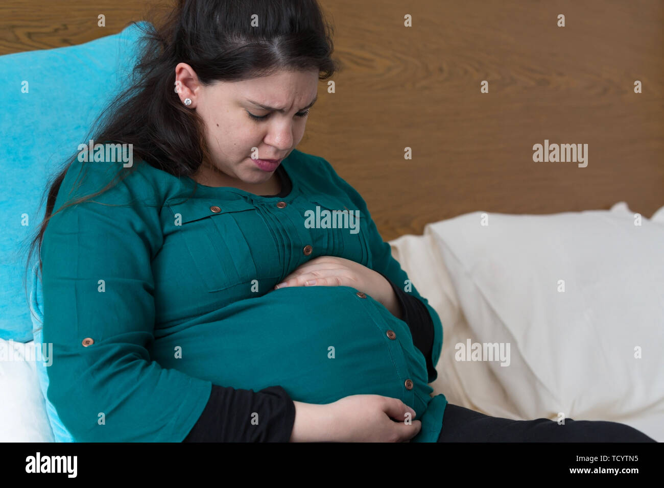 Young Expectant Mom Experiencing Practice Contractions Stock Photo