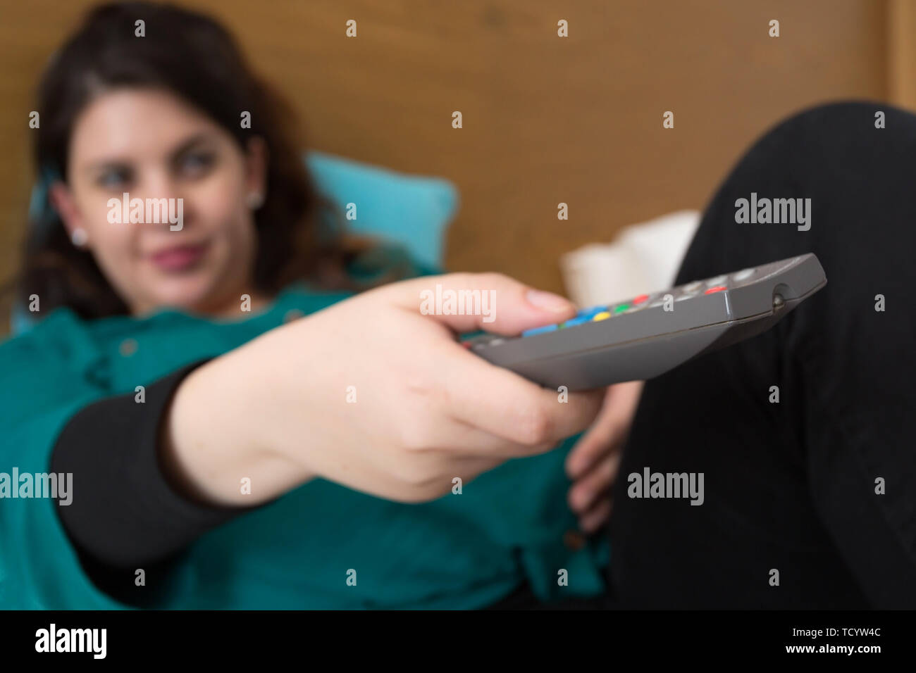 Pregnant Woman Watching TV and Unwinding After a Tough Day Stock Photo