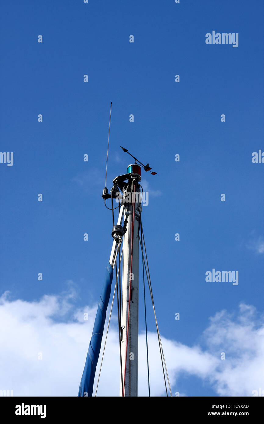 Sailboat rigging including radio antenna and navigation lights against a blue sky with space for copy Stock Photo