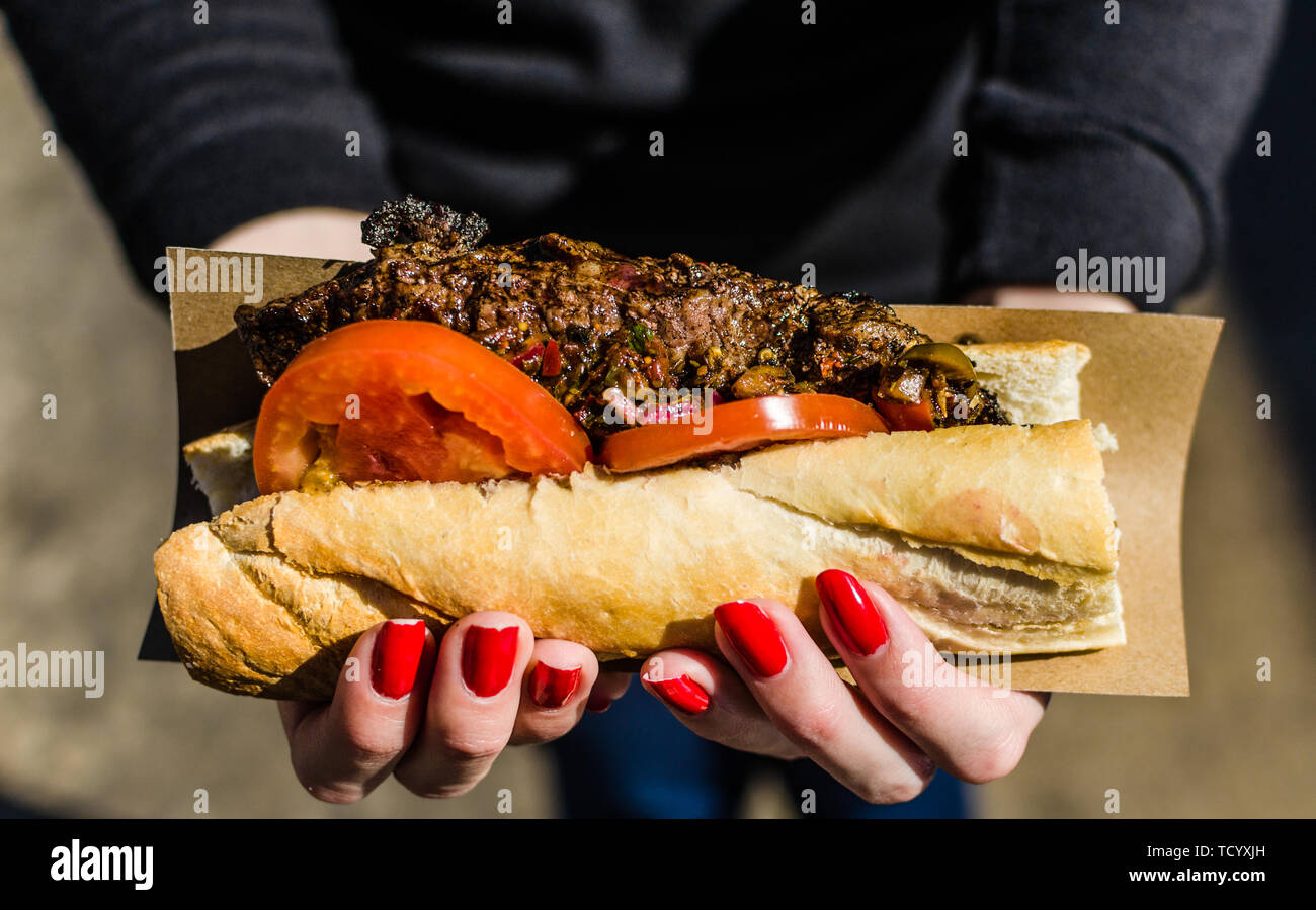 Argentina street food, sandwich with New York strip steak and chimichurri sauce Stock Photo