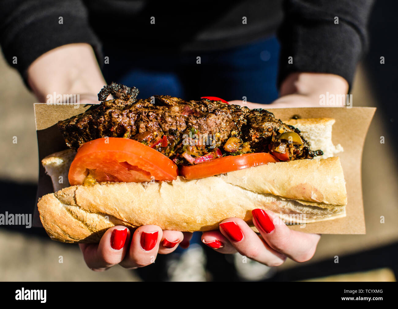 Argentina street food, sandwich with New York strip steak and chimichurri sauce Stock Photo