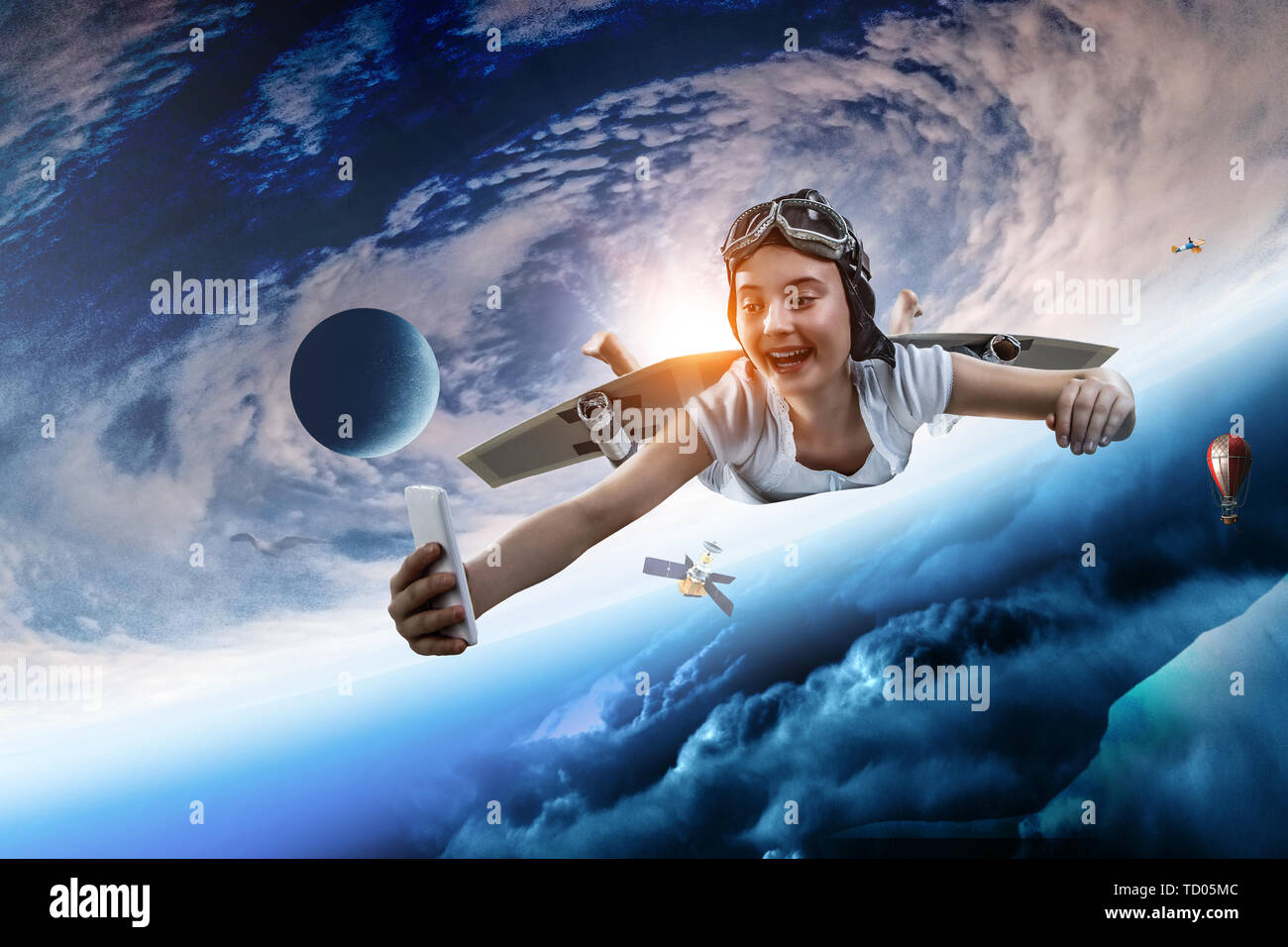Self Fly Girl flying with self-made plane wing. Mixed media Stock Photo - Alamy