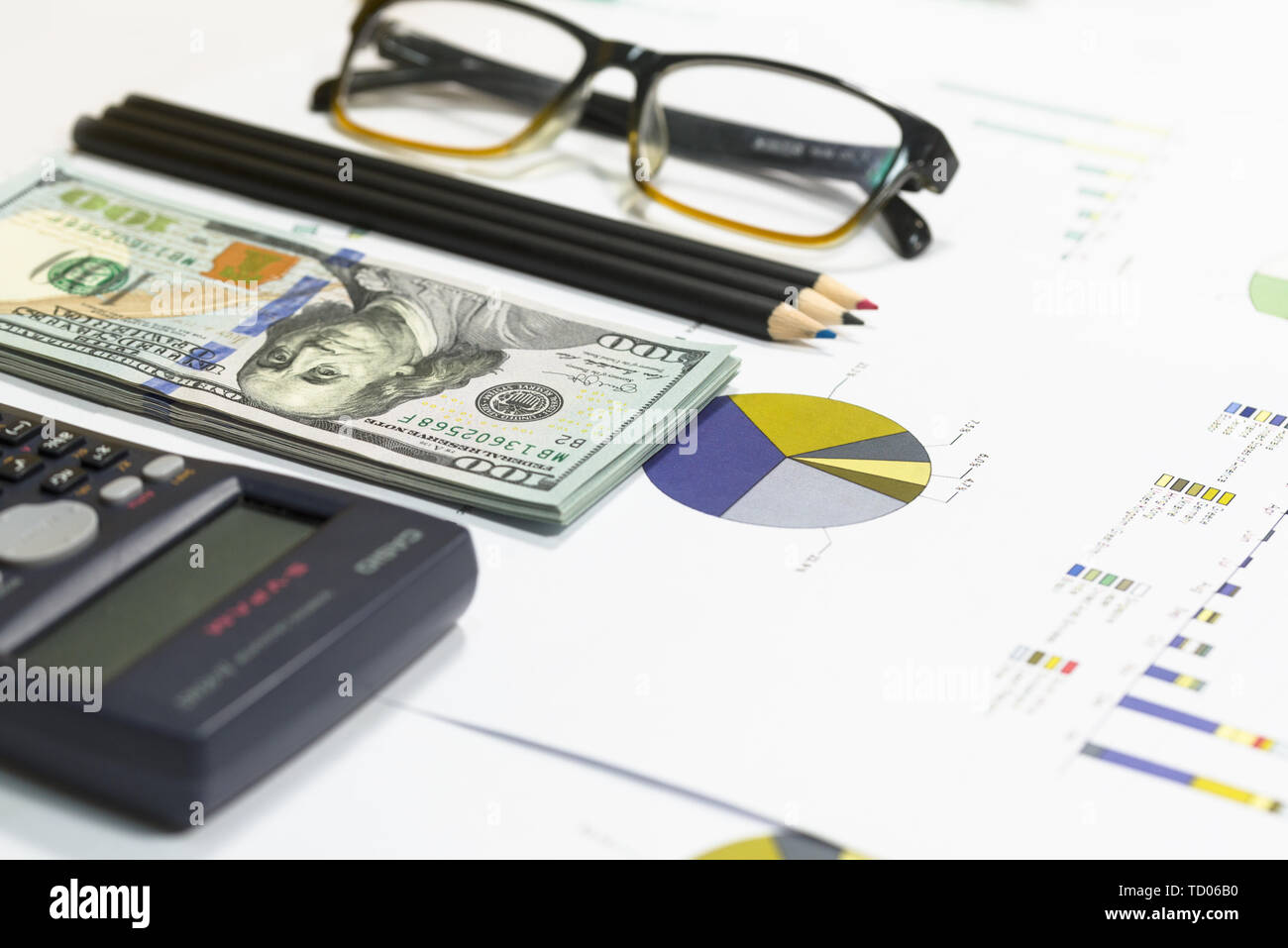 Dollar banknotes, calculator, pen, coffee, glasses and business chart ...