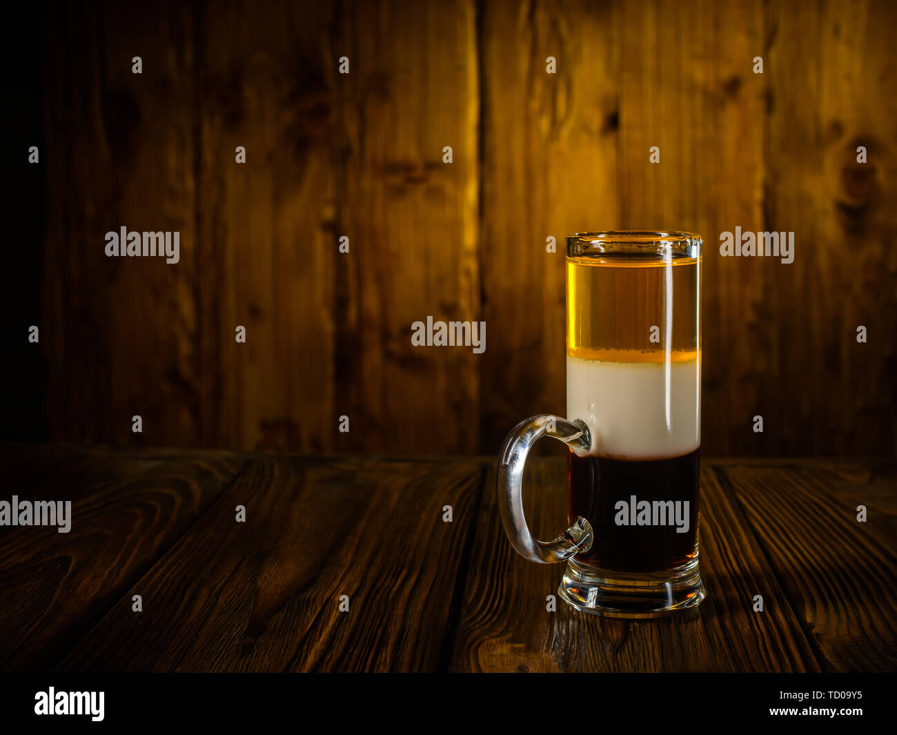 Alcoholic cocktail shot B52 on wooden vintage surface background Stock Photo
