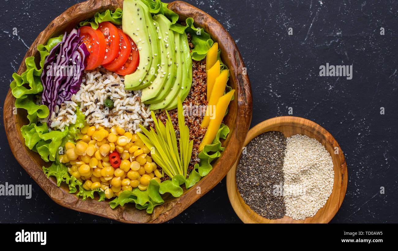 Healthy vegan superfood bowl with quinoa, wild rice, chickpea, tomatoes