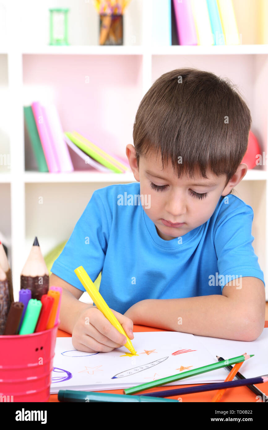 Cute little boy drawing in his album Stock Photo - Alamy