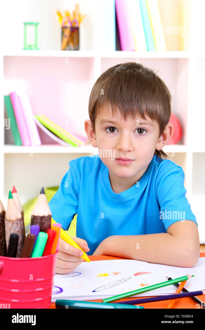 Cute little boy drawing in his album Stock Photo - Alamy