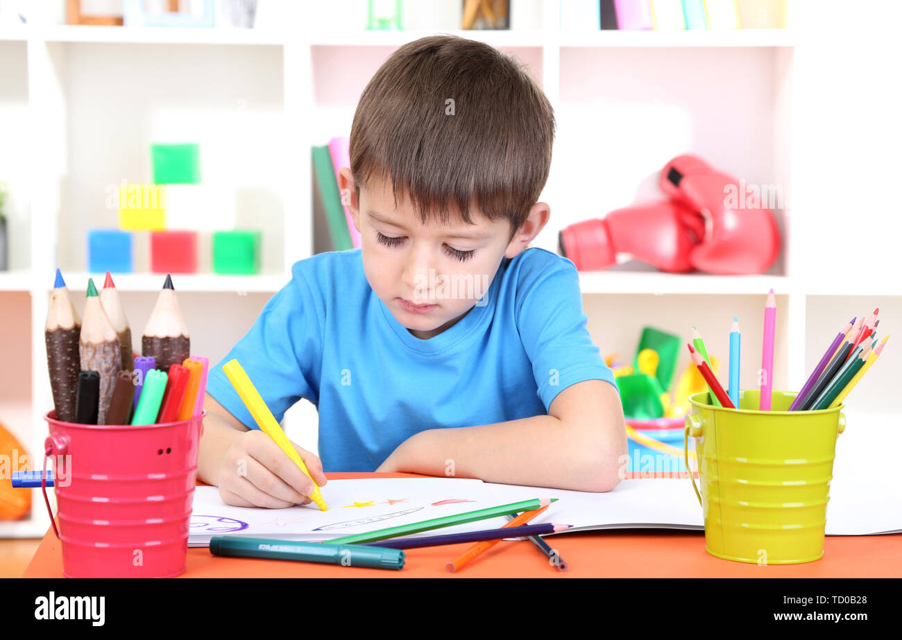 Cute little boy drawing in his album Stock Photo - Alamy