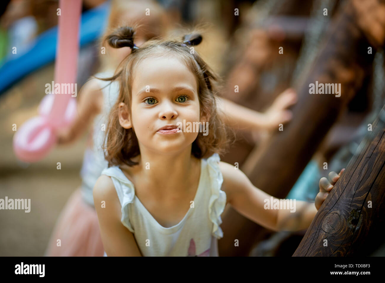 Portrait of cute little girl standing at playground on summer day Stock ...
