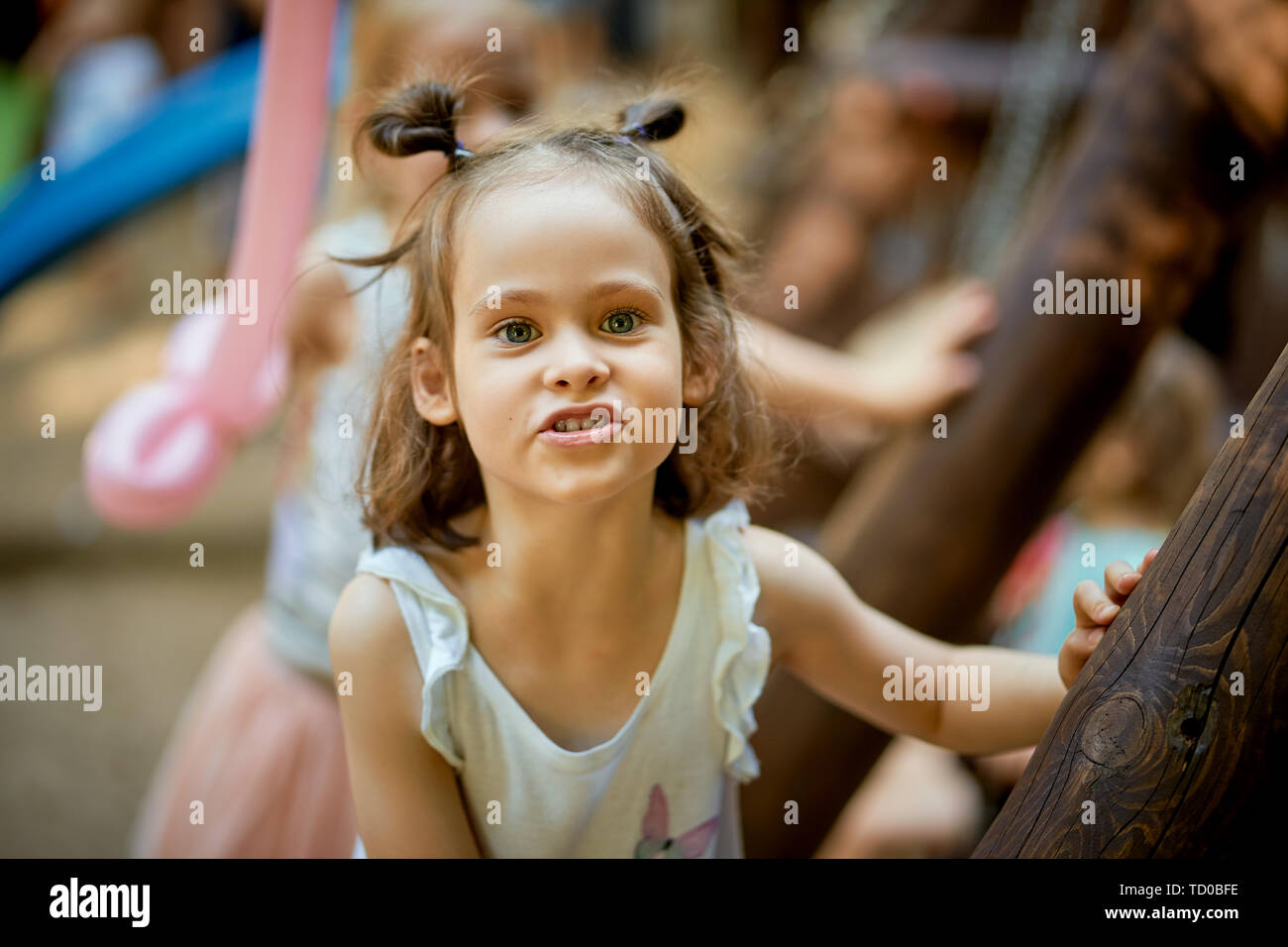 Portrait of cute little girl standing at playground on summer day Stock ...