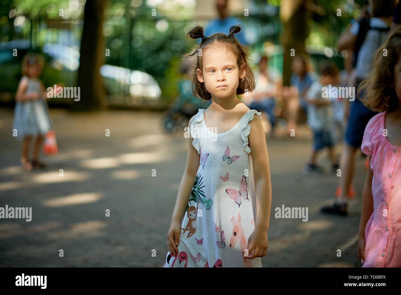 Portrait of cute little girl standing at playground on summer day Stock ...