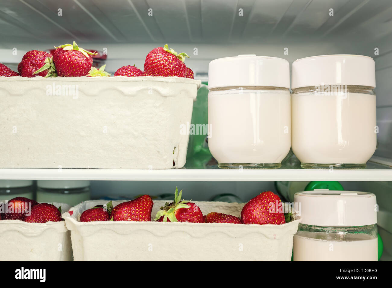 Refrigerator shelf with organic juicy strawberries in bio recycled