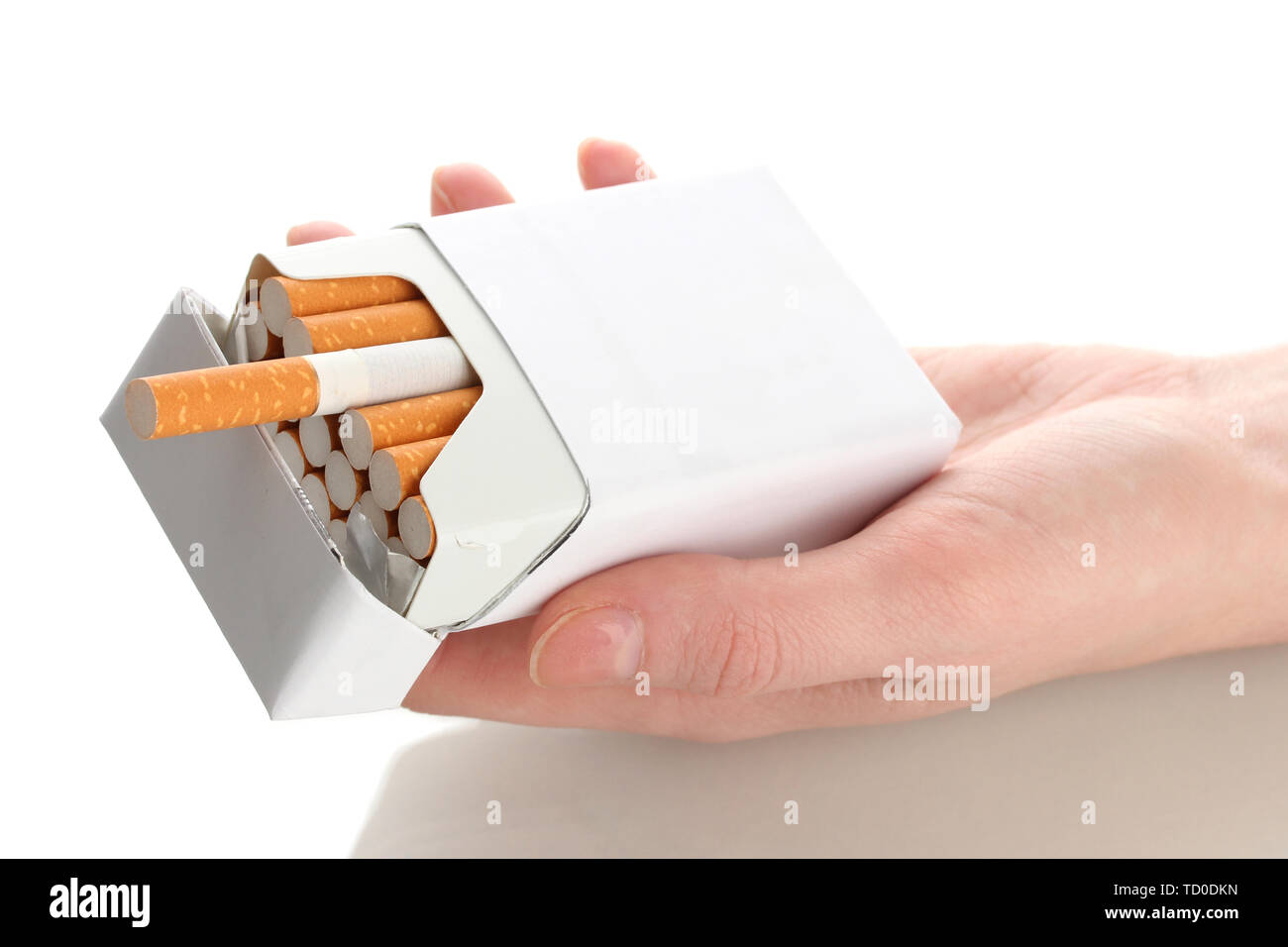hand holding a box of cigarettes Woman hand with box of cigarettes, isolated on a white Stock Photo