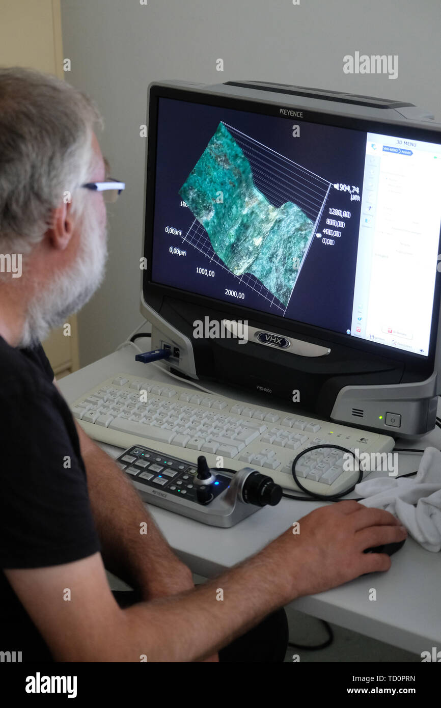 Halle, Germany. 03rd June, 2019. Christian Heinrich Wunderlich from the State Office for Monument Preservation and Archaeology Saxony-Anhalt sits in the workshop of the institution at a monitor on which a microscopic image of the Nebra Sky Disk is shown. (to dpa 'Researchers discover new gold traces on sky disk of Nebra') Credit: Sebastian Willnow/dpa-Zentralbild/dpa/Alamy Live News Stock Photo