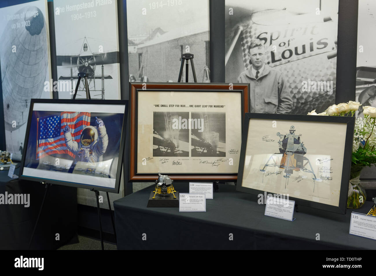 Garden City, New York, USA. 6th June, 2019. Three Apollo space memorabilia items, L-R, signed print by astronaut artist Alan Bean, a vintage transmission print, and a vintage lithograph of lunar module, are on display at Silent Auction fundraiser area at Cradle of Aviation Museum, during Apollo at 50 Anniversary Dinner, an Apollo astronaut tribute celebrating the Apollo 11 mission Moon landing. Credit: Ann Parry/ZUMA Wire/Alamy Live News Stock Photo