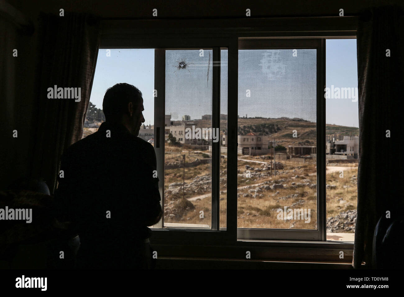 Nablus, Palestinian Territories. 11th June, 2019. A Palestinian security officer looks at a bullet hole inside the headquarters of the Palestinian Preventive Security (PPS), one of the security apparatus of the Palestinian Authority. In a rare incident Israeli soldiers had a shootout with Palestinian security forces over a case of mistaken identity. Reportedly only two Palestinians were injured. Credit: Ayman Nobani/dpa/Alamy Live News Stock Photo