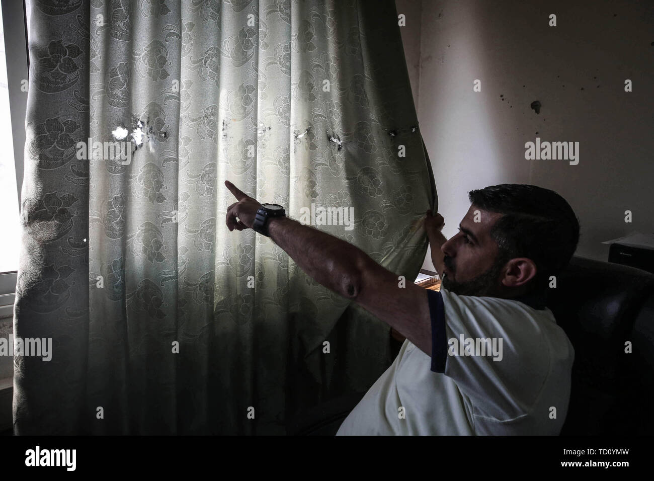 Nablus, Palestinian Territories. 11th June, 2019. A Palestinian security officer points at bullet holes inside the headquarters of the Palestinian Preventive Security (PPS), one of the security apparatus of the Palestinian Authority. In a rare incident Israeli soldiers had a shootout with Palestinian security forces over a case of mistaken identity. Reportedly only two Palestinians were injured. Credit: Ayman Nobani/dpa/Alamy Live News Stock Photo