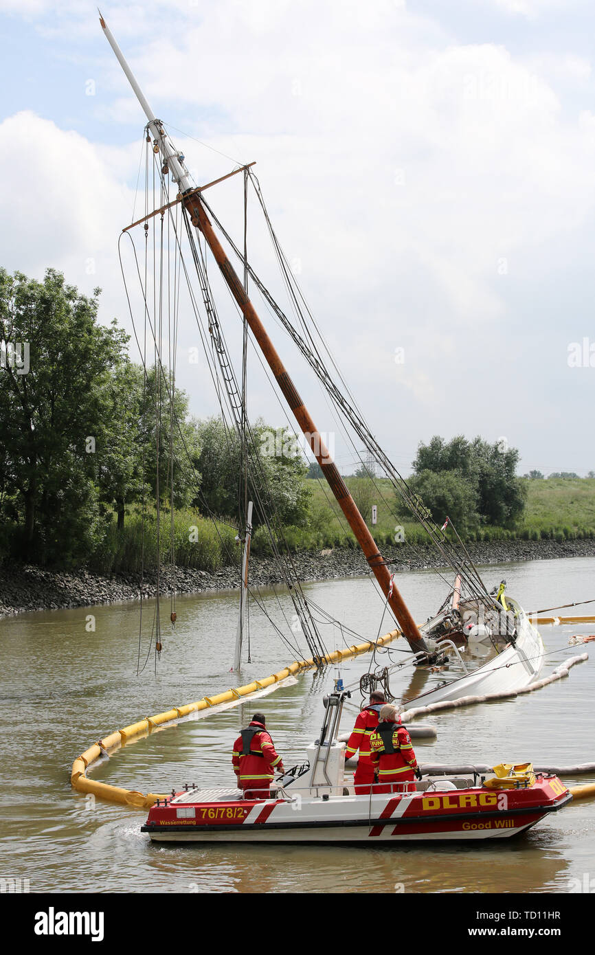 Stadersand, Germany. 11th June, 2019. Emergency forces are preparing the laying of new oil barriers around the sunken historic sailing ship 'No 5 Elbe' in the harbour of Stadersand. Operating fluids had leaked from the hull of the sailing ship, and the fire brigade was on site with the support of the German Federal Agency for Technical Relief and the German Aerospace Center (DLRG). The historic sailing ship, which has only recently been extensively renovated, collided with a container ship on the Elbe and sank. Credit: Bodo Marks/dpa/Alamy Live News Stock Photo