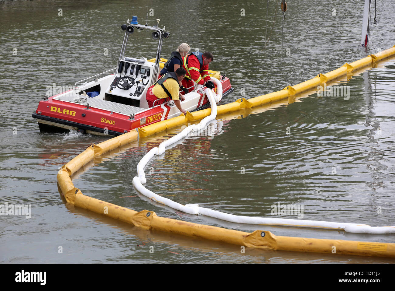 Stadersand, Germany. 11th June, 2019. Emergency forces lay new oil barriers around the sunken historic sailing ship 'No 5 Elbe' in the harbour of Stadersand. Operating fluids had leaked from the hull of the sailing ship, and the fire brigade was on site with the support of the German Federal Agency for Technical Relief and the German Aerospace Center (DLRG). The historic sailing ship, which has only recently been extensively renovated, collided with a container ship on the Elbe and sank. Credit: Bodo Marks/dpa/Alamy Live News Stock Photo