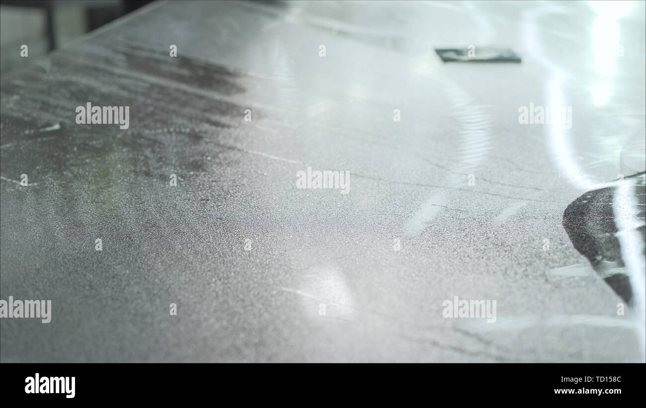 Car wrapping specialist putting vinyl foil or film on car. Detailing