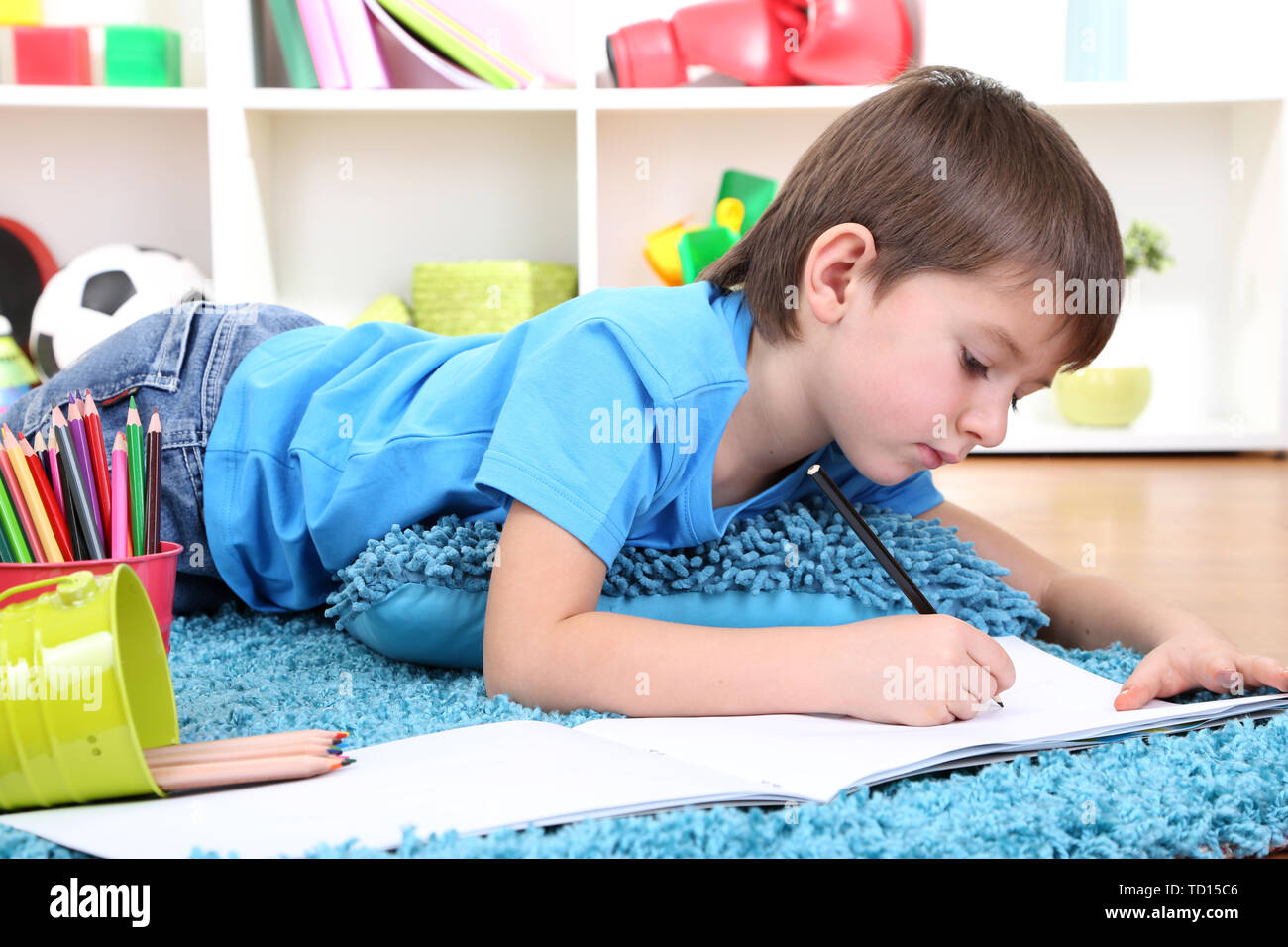 Cute little boy drawing in his album Stock Photo - Alamy