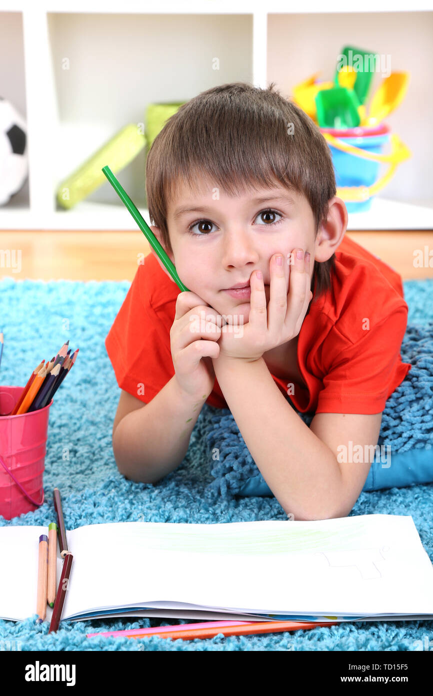 Cute little boy drawing in his album Stock Photo - Alamy