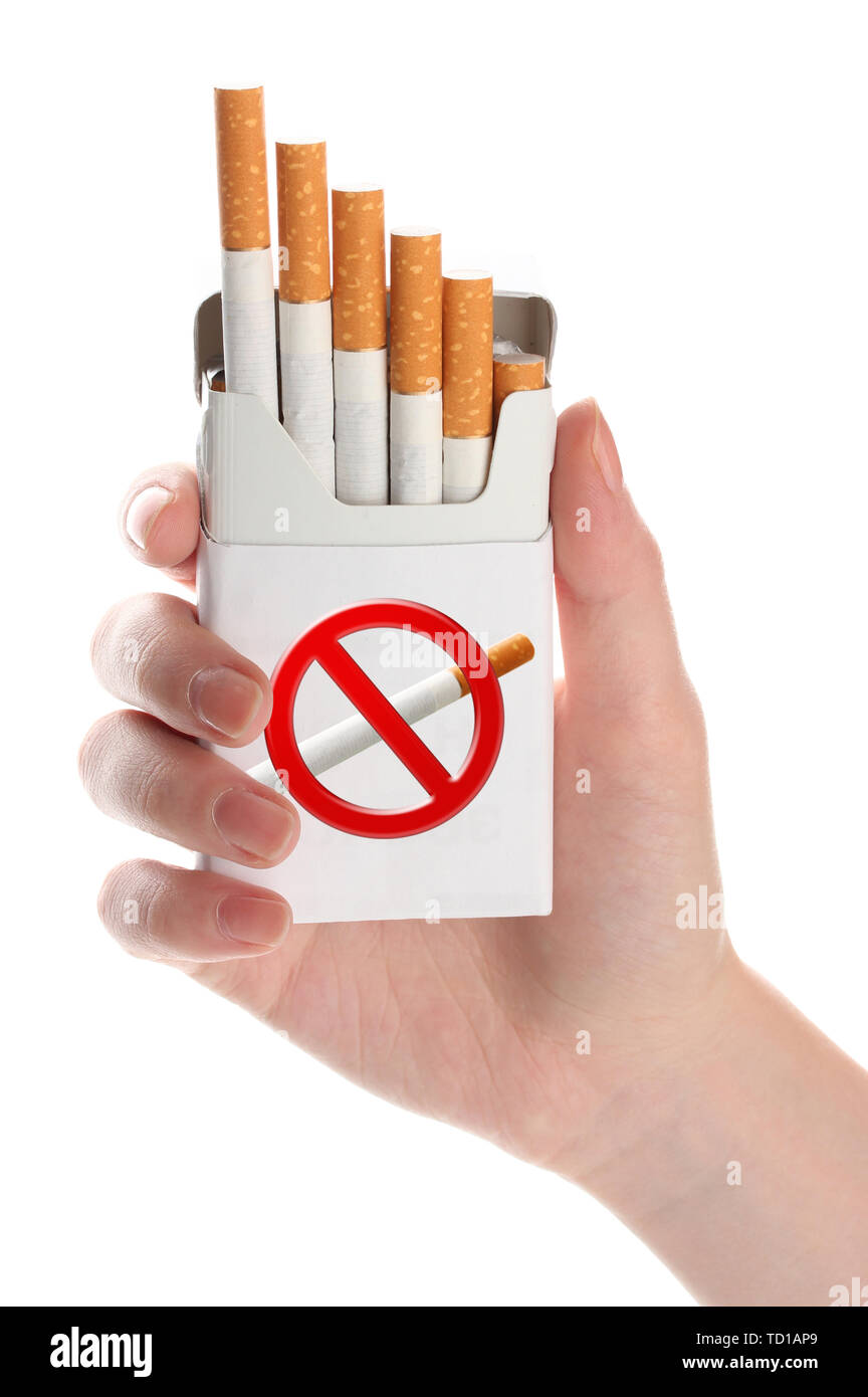 hand holding pack of cigarettes Woman hand with box of cigarettes, isolated on white Stock Photo