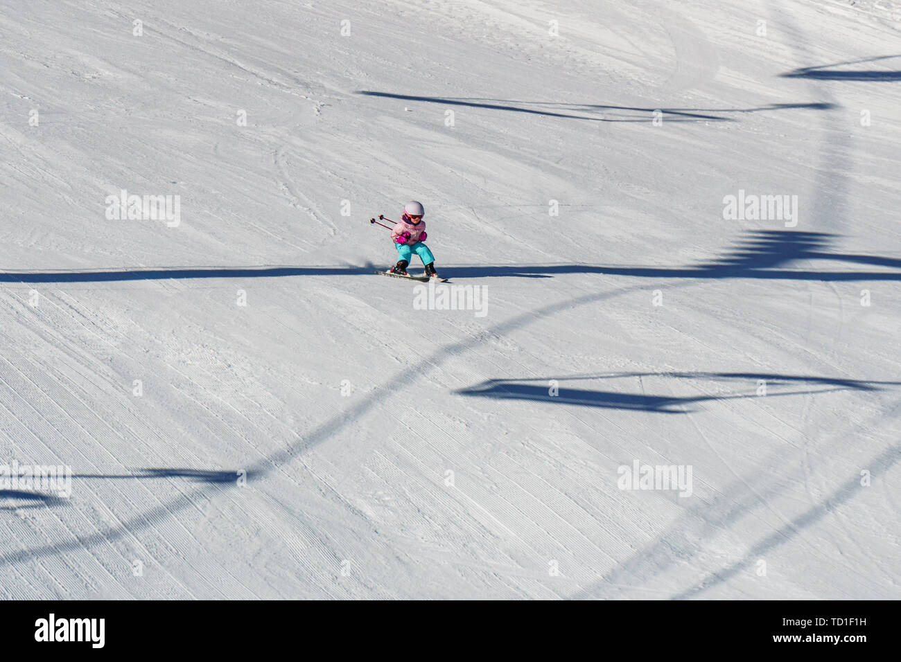 KIMBERLEY, CANADA - MARCH 22, 2019: Mountain Resort view early spring child skiing. Stock Photo