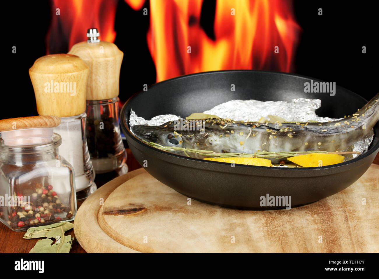 Fish in a frying pan over an outdoor fire Stock Photo - Alamy