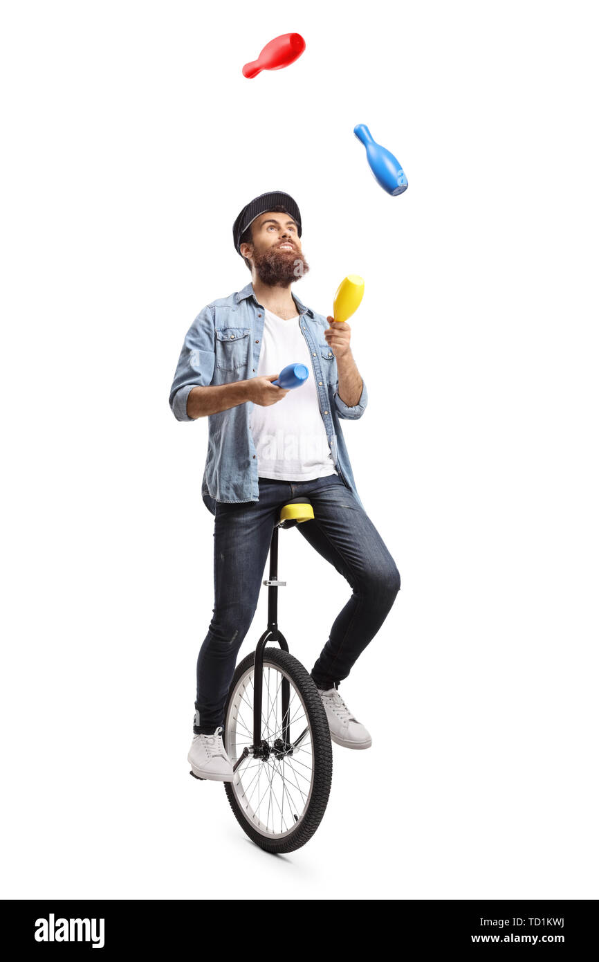 Full length shot of a bearded man on a unicycle juggling with clubs