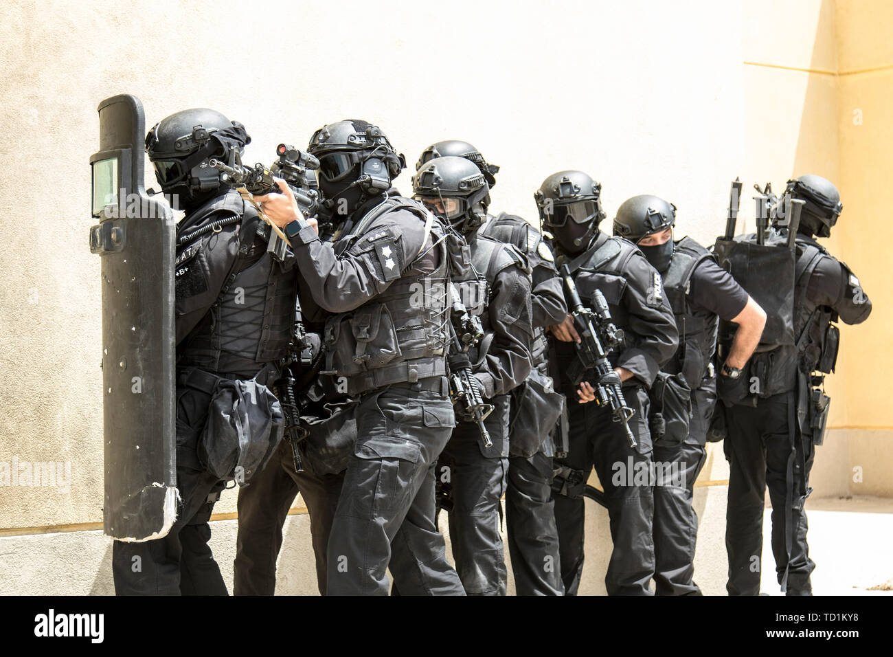 Members of the Kuwait Ministry of Interior’s Special Weapons and Tactics team prepare to breach a building while pulling security on May 2, 2019 during a joint exercise with a simulated terrorist, explosive ordnance, and chemical situation at the Kuwait Special Forces Training Center. The exercise was crafted to build a shared understanding of Kuwait Civil Authorities and U.S. Forces procedures while reacting to any disaster, natural and manmade alike. Stock Photo